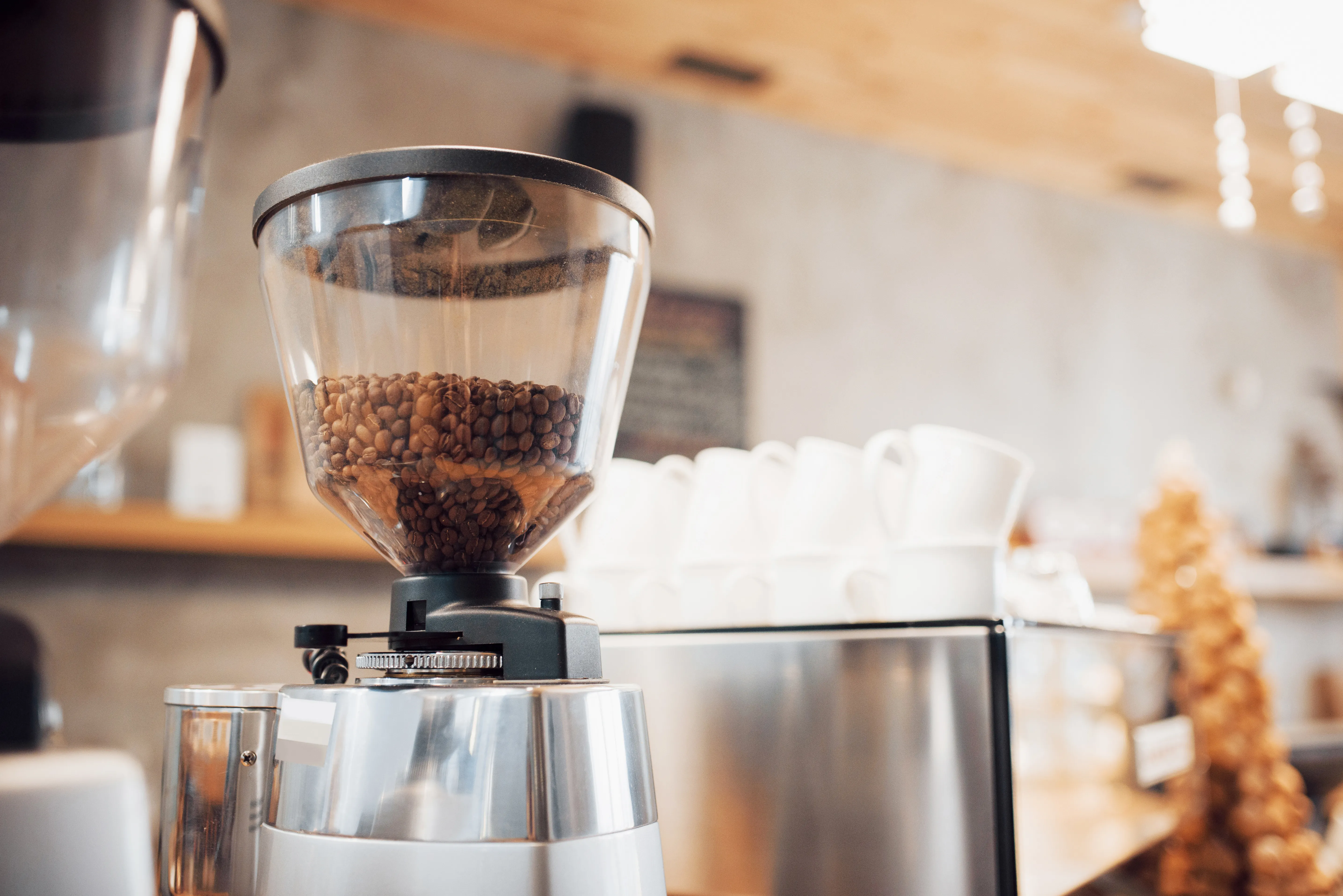 A cafe grinder on the counter beside a scale